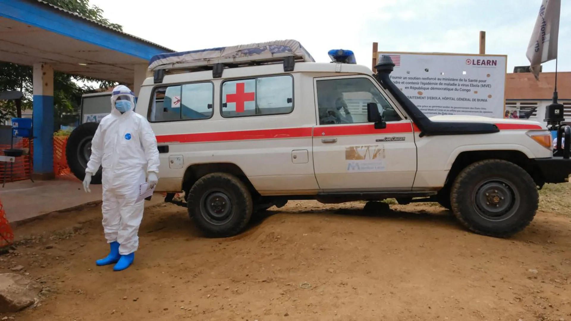 A health officer in personal protective equipment stands at an international airport health desk as India activates Air Suvidha 2.0 for Ebola passenger screening at points of entry.