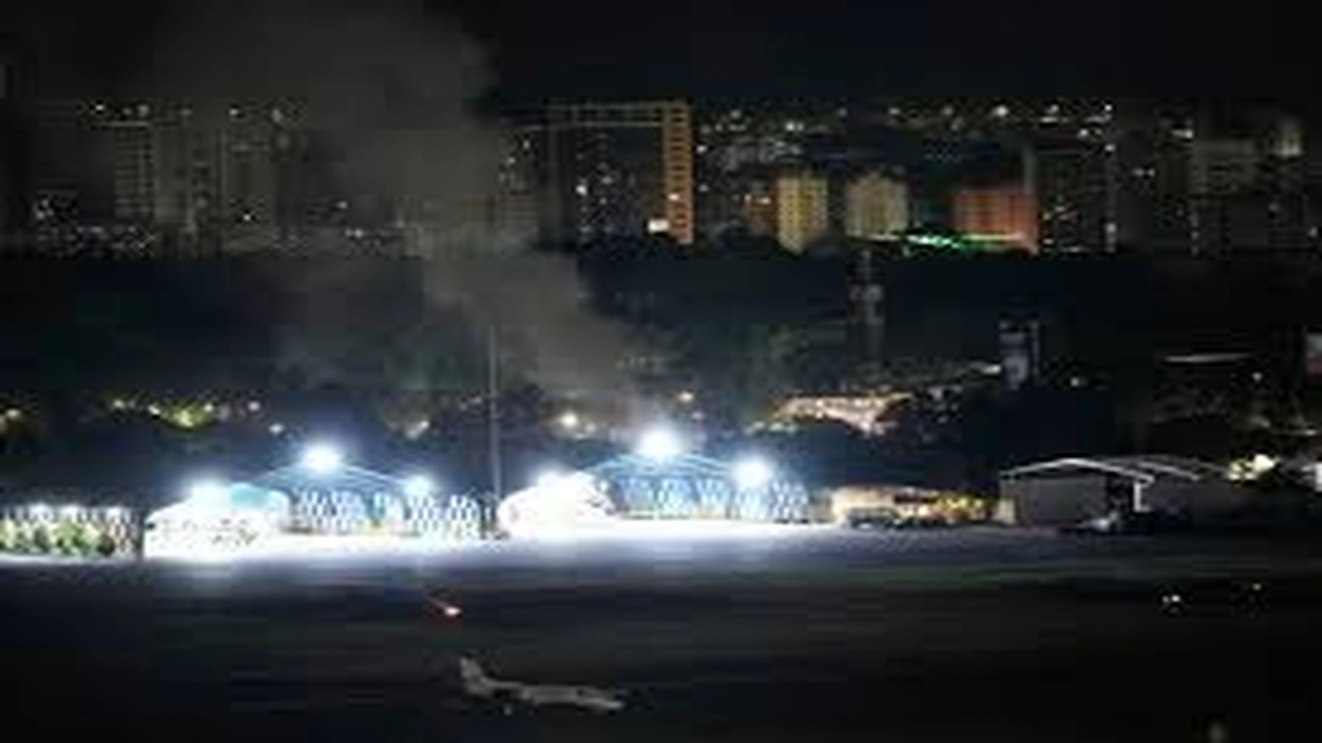Night view of Caracas with smoke rising after multiple explosions as regional tensions escalate in Venezuela