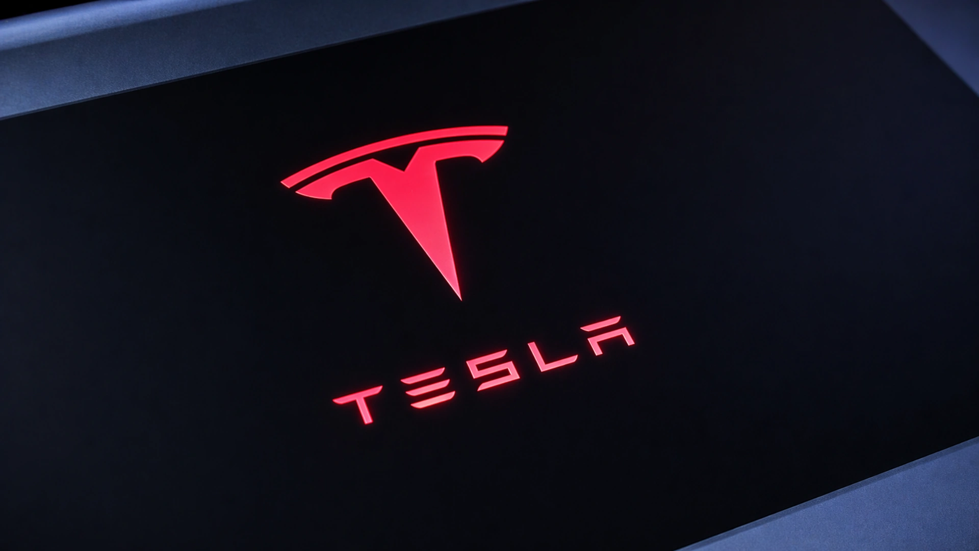 Tesla logo representing Tesla's $25 billion 2026 investment plan in AI, robotaxis and Optimus robotics amid investor scrutiny